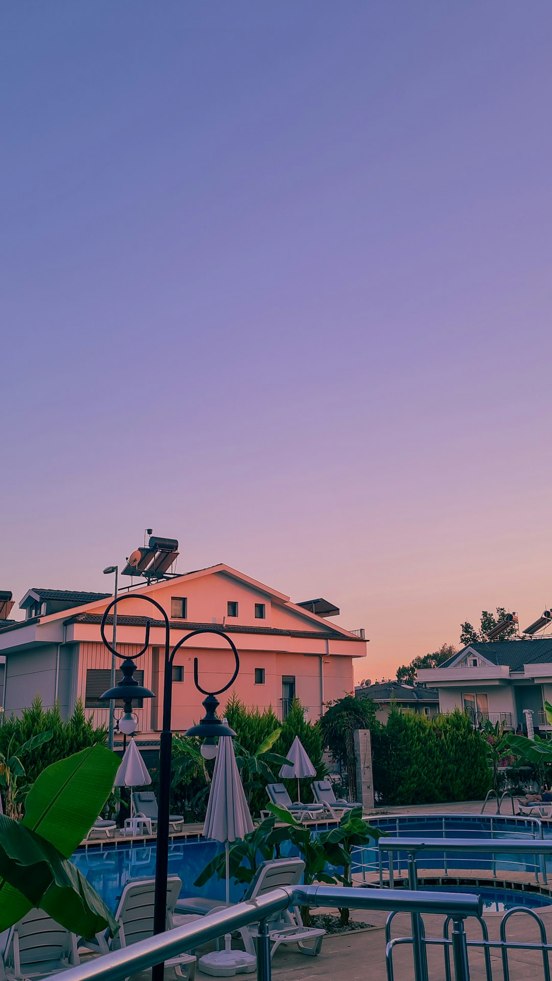 a-view-of-a-swimming-pool-from-a-balcony-y8vaqjstz8e